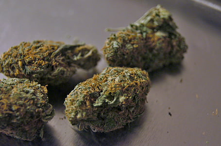 four rolled green kush on gray stainless steel surface thumbnail