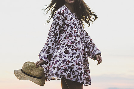 woman holding straw sunhat thumbnail