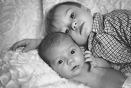 two babies lying on bed thumbnail