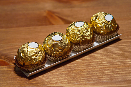 four chocolates on wooden surface thumbnail