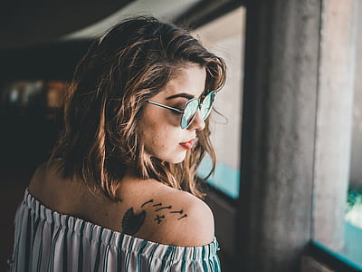 woman wearing gray off-shoulder top and sunglasses in room thumbnail