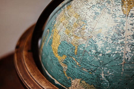 shallow focus photography of blue and brown desk globe thumbnail