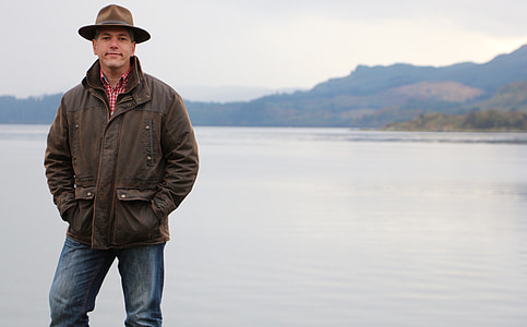 man standing beside body of water photo thumbnail