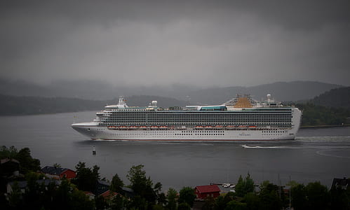 white cruise ship near island thumbnail