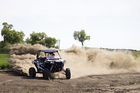 person riding dune buggy during daytime thumbnail