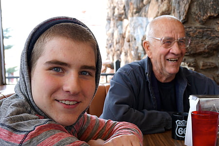 two smiling man wearing black jacket beside boy wearing hoodie thumbnail