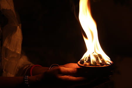 man holding cup of charcoal fire thumbnail