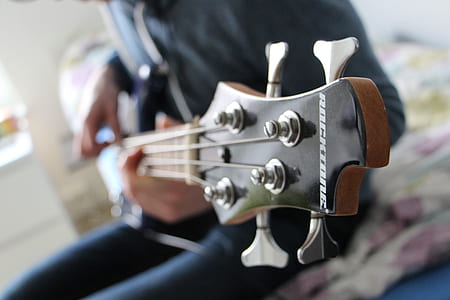 selective focus photo of black and brown guitar headstock thumbnail
