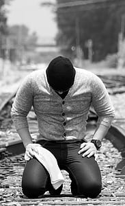 grayscale photo of man sitting thumbnail