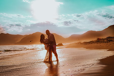 man and woman dancing beside seashore thumbnail