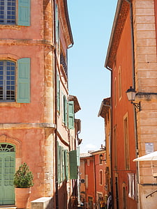 two orange houses under blue sky thumbnail