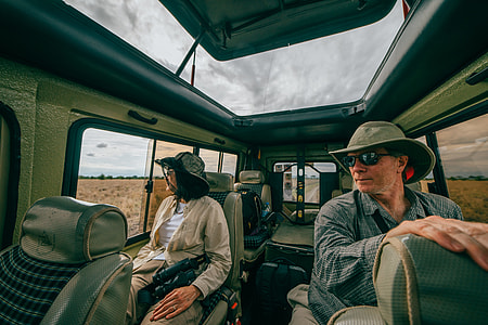 man and woman inside truck watching outside during daytime thumbnail