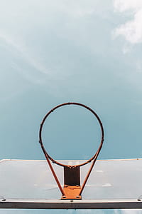 low angle photo of basketball hoop under blue sky at daytime thumbnail