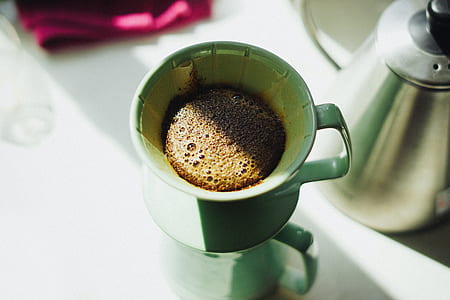 almost full green ceramic teacup with saucer thumbnail