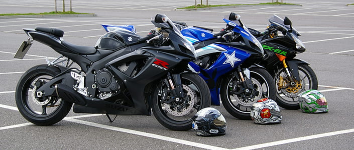 two black and one blue sportbikes parked ahead thumbnail