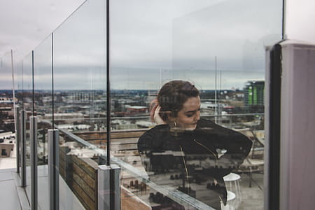 woman leaning on glass wall thumbnail