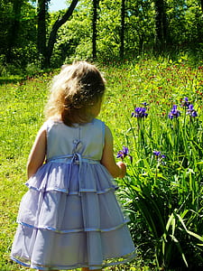 toddler picking flowers at daytime thumbnail