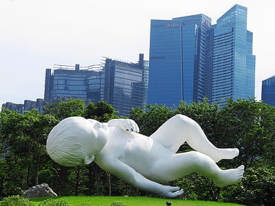 lying baby statue in front of high-rise building thumbnail