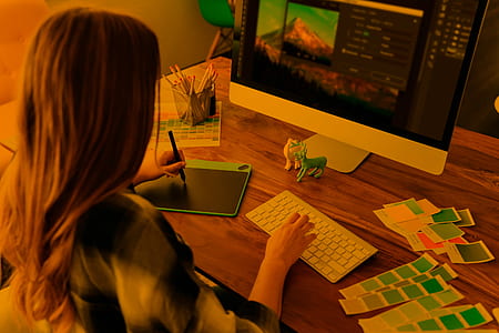 woman using silver iMac and Photoshop editor close-up photo thumbnail