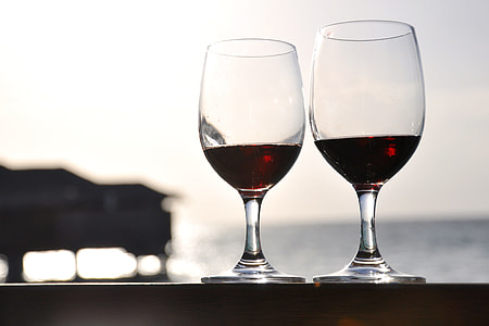selective focus photography of two wine glasses with red liquid thumbnail