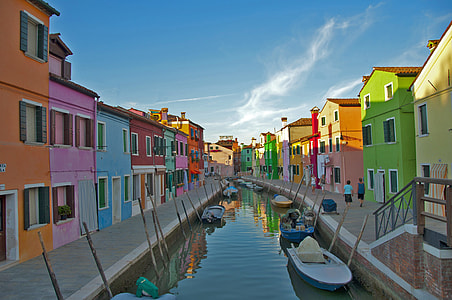 architectural photography of multicolored building and boats during daytime thumbnail