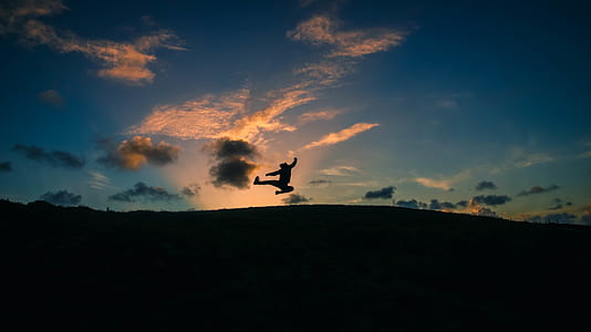 silhouette of person jumping in mid air thumbnail