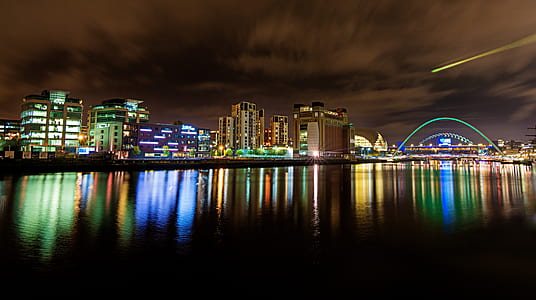 Cityscape at Nighttime Reflecting on Body of Water thumbnail