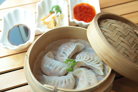 steamed dimsum in round brown steamer bowl thumbnail