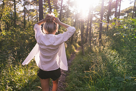 woman walking on pathway in forest thumbnail