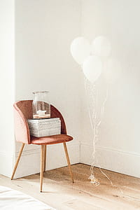 clear glass jar on top of chair beside balloons thumbnail