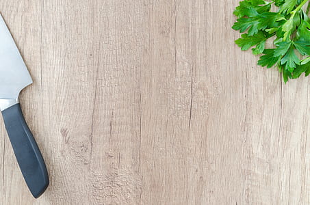 gray and black kitchen knife on brown wooden board thumbnail