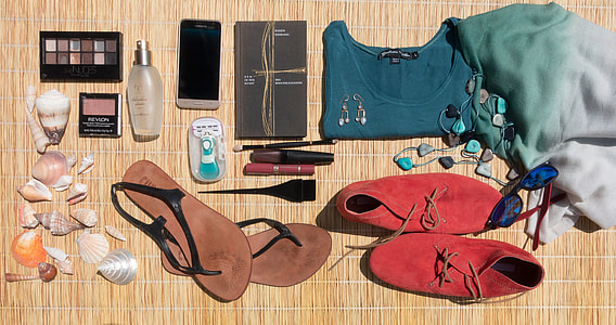 assorted-color pairs of shoes and makeup bottles thumbnail