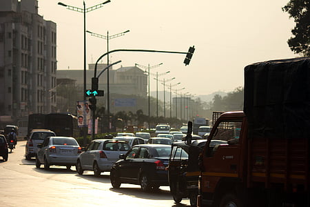 vehicles moving on concrete road near buildings during daytime thumbnail