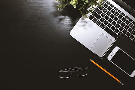 Black work table with laptop, smartphone and glasses thumbnail