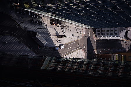 aerial photography of vehicles on road in between of two high-rise buildings thumbnail