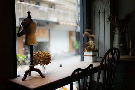 brown wooden desk beside two wooden chairs thumbnail
