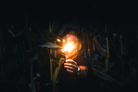 man holding sparkling sparkler thumbnail