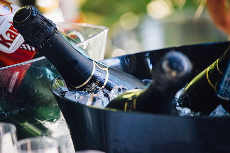 three wine bottles on bucket with ice thumbnail