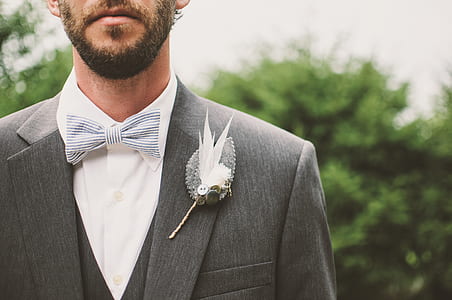 man wearing gray suit jacket, white necktie, and white dress shirt thumbnail