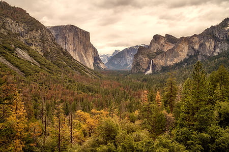 landscape photography of mountains surrounded by green leafed trees during daytime thumbnail