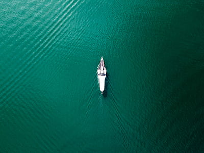 white boat on body of water during dayime thumbnail