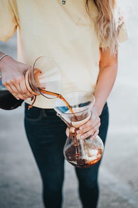 woman holding glass vase during daytime thumbnail