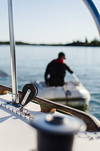 man riding on boat while fishing thumbnail