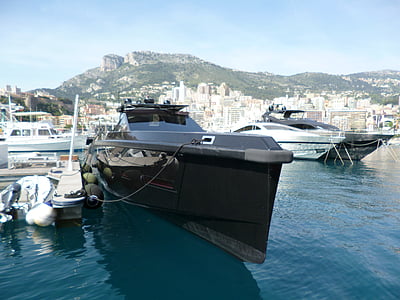black powerboat beside dockside thumbnail