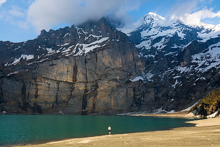 body of water beside mountain thumbnail