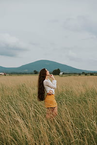 woman looking up in the middle of paddy field thumbnail