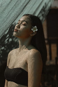 woman wearing black strapless bra standing in front of black net during daytime thumbnail