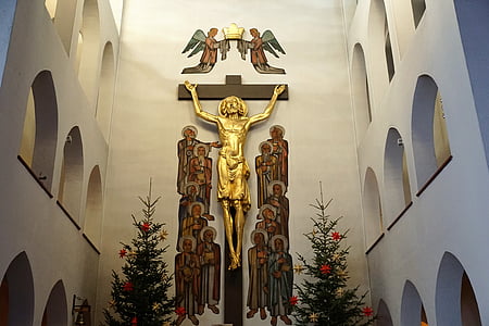gold-colored crucifix on wall thumbnail