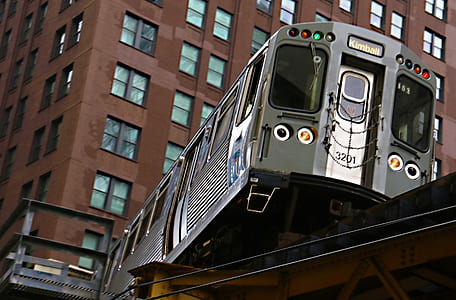 low-angle photography of train near buildings at daytime thumbnail