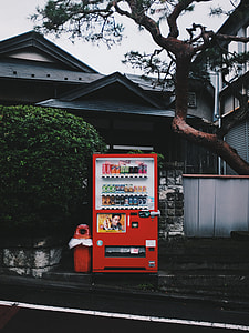 red vending machine in front of house during daytime thumbnail